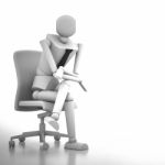 Businessman Doll Sitting On Chair Stock Photo