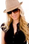 Portrait Of Smiling Female Wearing Hat And Sunglasses Stock Photo