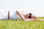 Women Lie Down On Grass Stock Photo