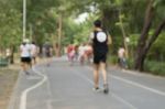 Blurred Image Of People Doing Exercise In Park Stock Photo