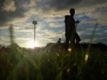 Silhouette  Running On Road At Sunrise Stock Photo