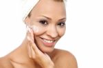 Pretty Woman Applying Face Cream Stock Photo