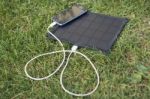 Mobile Phone Charging With Solar Energy - Charger Stock Photo