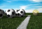 Golden Football On Soccer Field Stock Photo