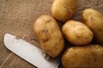 Potato On Still Life Sack Background Stock Photo