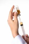 Syringe And Nurse's Hand Stock Photo