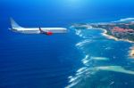 Airplane Flying Above Clouds In Sunlight Stock Photo