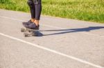 Young Woman Skateboarding In The Park Stock Photo