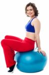 Woman Relaxing On Big Exercise Ball After Workout Stock Photo