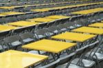 Rows Of Yellow Metal Tables And Chairs Stock Photo