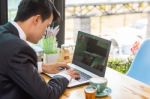 Business Man Using Portable Laptop Computer While Sitting In The Stock Photo