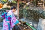 Asian Women In Traditional Japanese Kimonos At Fushimi Inari Shrine In Kyoto, Japan Stock Photo