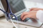 Doctor Hands Typing On Laptop Keyboard Stock Photo