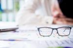 Tired Businessman Sleeping While Calculating Expenses At Desk I Stock Photo