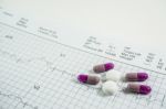 Heap Of Medicine Pills On Cardiogram Grid Paper. Selective Focus Stock Photo