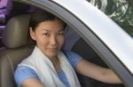 Smiling Woman Sitting In Car Stock Photo