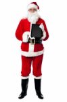 Saint Nicholas Displaying A Brand New Tablet Device Stock Photo