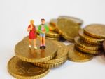 Miniature Children Stand On Euro Coins. Family Future Money Plan Stock Photo