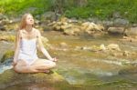 Beautiful Woman Practive Yoga On River In Nature Stock Photo