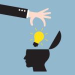 Businessman Hand Put Bright Light Bulb In Human Head Stock Photo