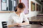 Portrait Of Thai Adult Businesswoman Beautiful Girl Using Her Tablet Stock Photo