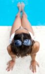 Pretty Girl Relaxing At The Swimming Pool In The Summertime Stock Photo