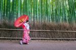 Bamboo Forest. Asian Woman Wearing Japanese Traditional Kimono At Bamboo Forest In Kyoto, Japan Stock Photo