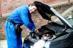 Young Mechanic Inspecting  Car Parts Stock Photo