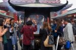 People Fan Incense Smoke At Sensoji Temple Stock Photo