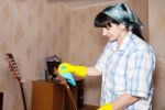 Woman Cleaning A Guitar With A Rag Stock Photo