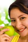 Young Lady Holding An Apple Stock Photo