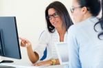 Two Business Woman Working In Office With Computer Stock Photo