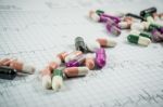 Heap Of Medicine Pills On Cardiogram Grid Paper. Selective Focus Stock Photo