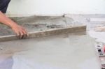 Builder Worker Plastering Concrete At Floor Stock Photo