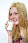 Blond Girl Drinking Glass Of Milk Stock Photo