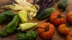 Several Vegetables On Wooden Chopping Board And Table Stock Photo