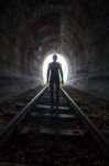 Man In A Tunnel Looking Towards The Light Stock Photo