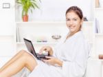 Woman In Bathrobe With Computer Stock Photo