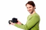 Photographer Resetting The Camera Settings Stock Photo