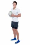 Full Length Portrait Of A Rugby Player Holding Ball Stock Photo