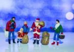 Miniature Santa Claus And Family With Beautiful Light Bokeh Back Stock Photo