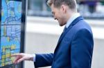 Businessman Checking A Bus Timetable Stock Photo