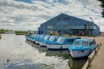 View Of Blue Boats For Hire At Potter Heigham Stock Photo