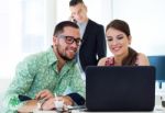 Casual Executives Working Together At A Meeting With Laptop Stock Photo