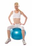 Female Sitting On Exercise Ball Stock Photo