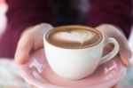 Hands Of Woman Barista Serving A Cup Of Cappucino Stock Photo