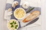 Baguette With Herb Butter And Rosemary Thyme On Rustic Wooden Background Stock Photo