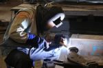 Industrial Worker Welding In Factory Stock Photo