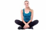 Female Trainer Sitting With Legs Crossed Stock Photo