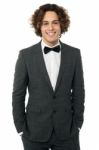 Elegant Man In Tuxedo Posing Over White Stock Photo